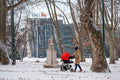 Woman with a stroller in the snowy City Park #1200